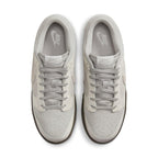 Nike Dunk Low Ironstone sneakers in light gray with dark sole, showcasing a sleek and modern design from above.