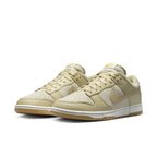Nike Dunk Low Khaki Suede Gum shoes with perforated toe and classic Swoosh in a beige colorway.