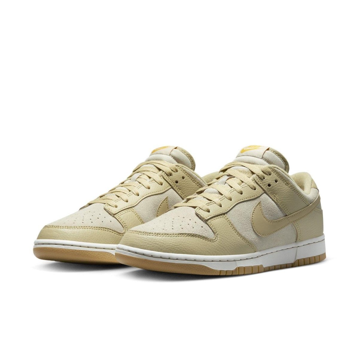 Nike Dunk Low Khaki Suede Gum shoes with perforated toe and classic Swoosh in a beige colorway.