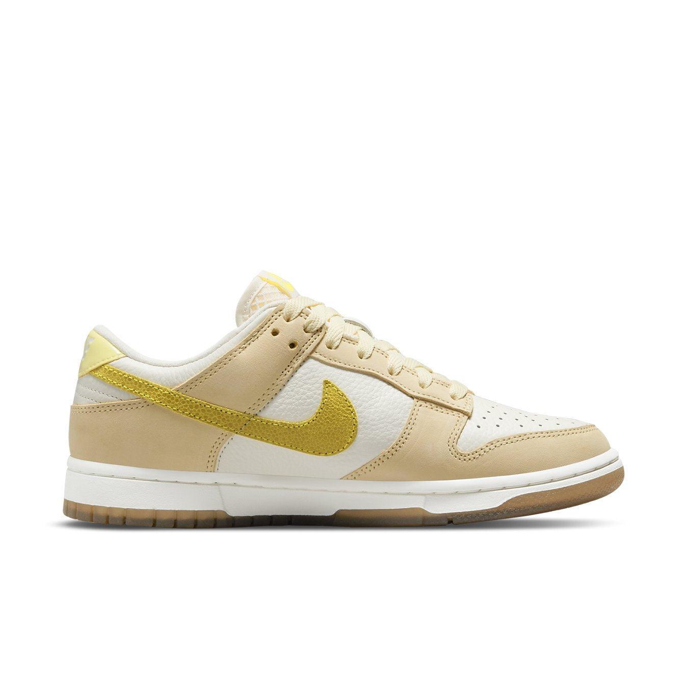 Nike Dunk Low Lemon Drop Women's sneaker in beige and white with bright yellow Swoosh and lemon embroidery.