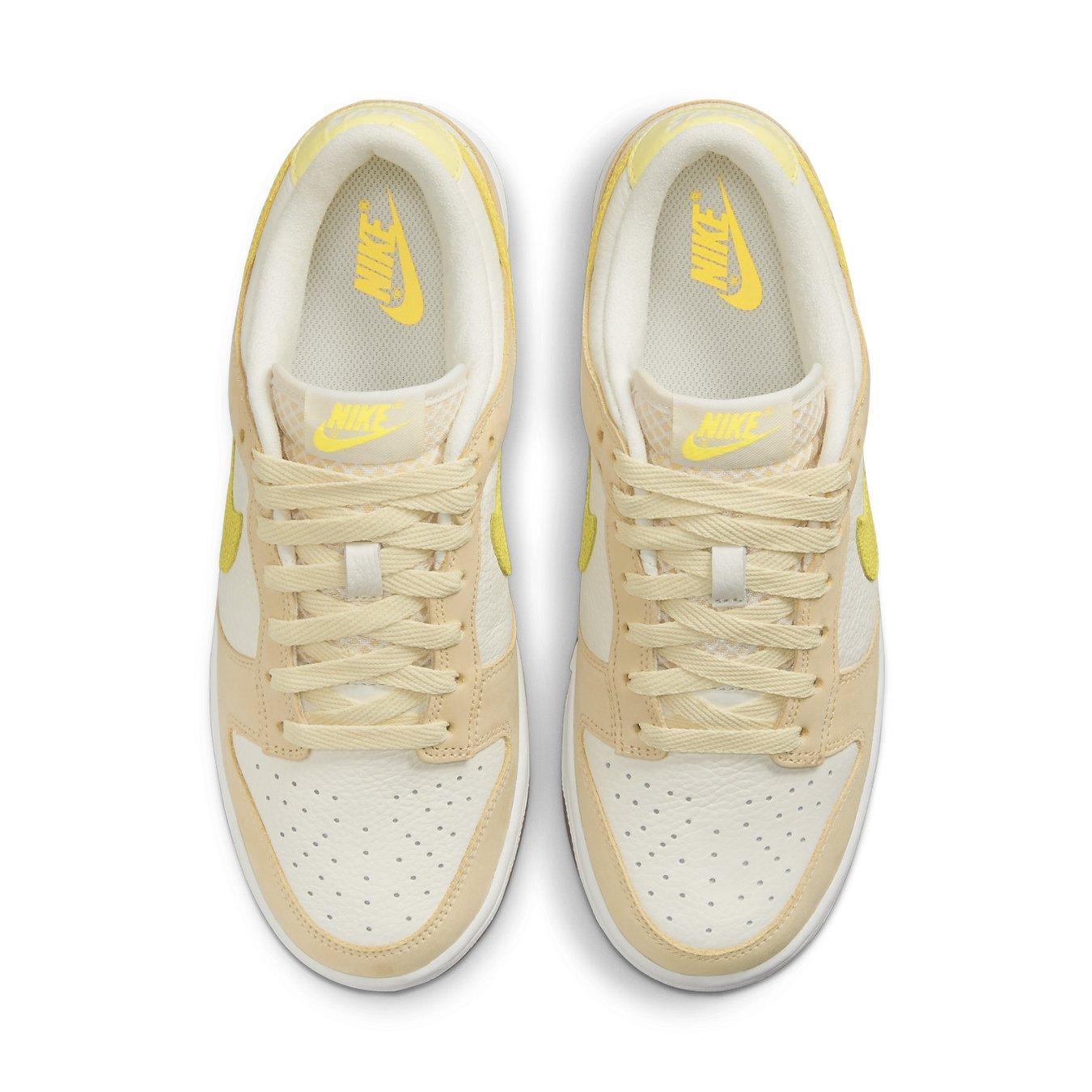 Nike Dunk Low Lemon Drop (W) featuring beige and yellow colorway, premium leather upper, and iconic silhouette.