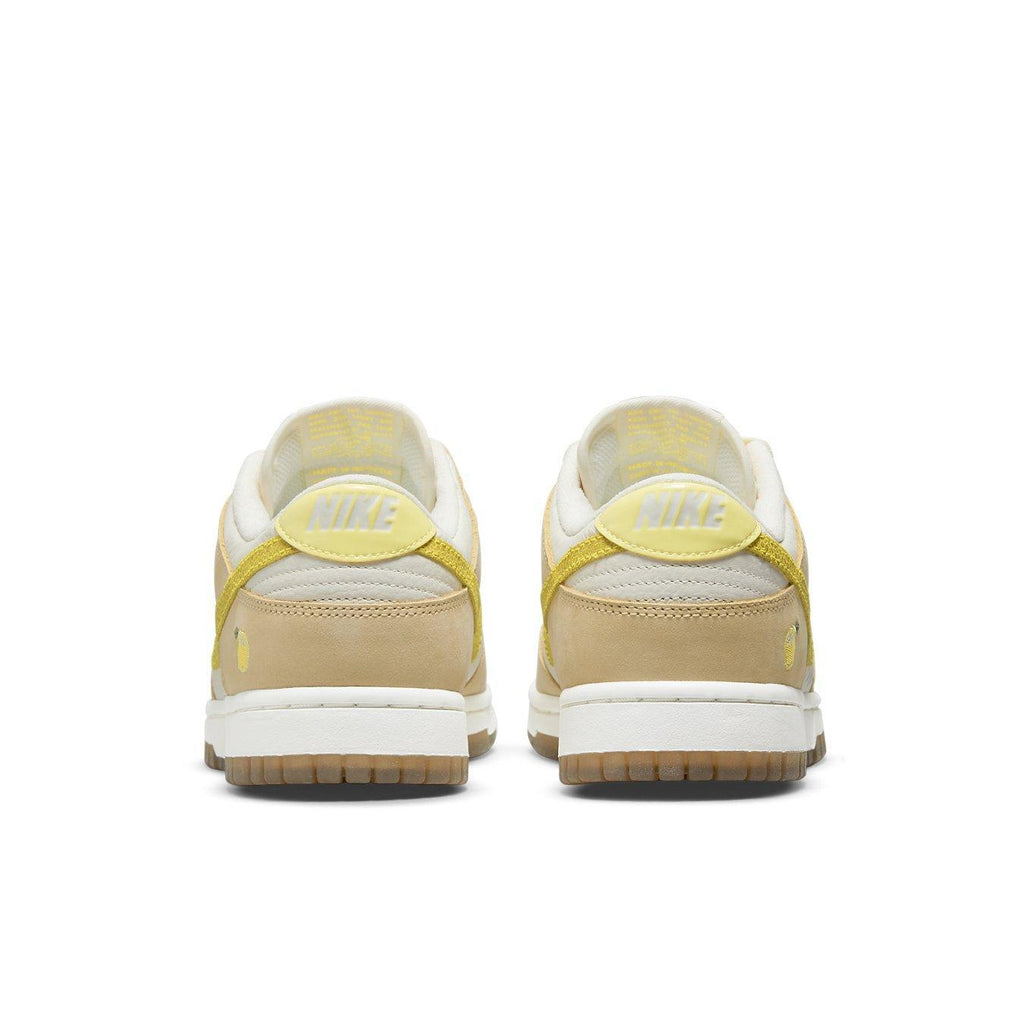 Nike Dunk Low Lemon Drop sneakers rear view showcasing yellow details and lemon embroidery on the heel.