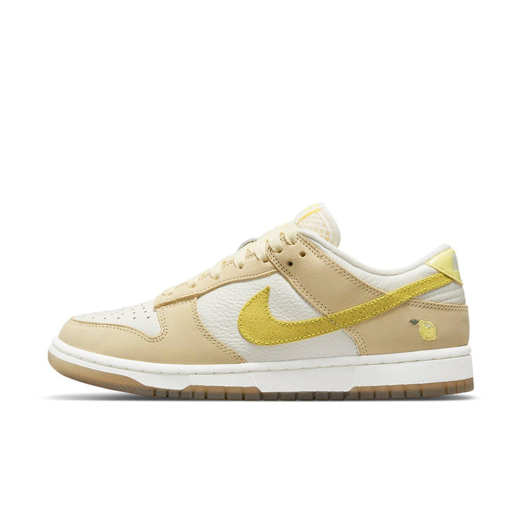 Nike Dunk Low Lemon Drop women's sneaker in beige and white with bright yellow Swoosh and lemon embroidery.