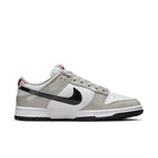 Nike Dunk Low Light Iron Ore sneakers in white and grey with glossy black Swoosh and red detailing.