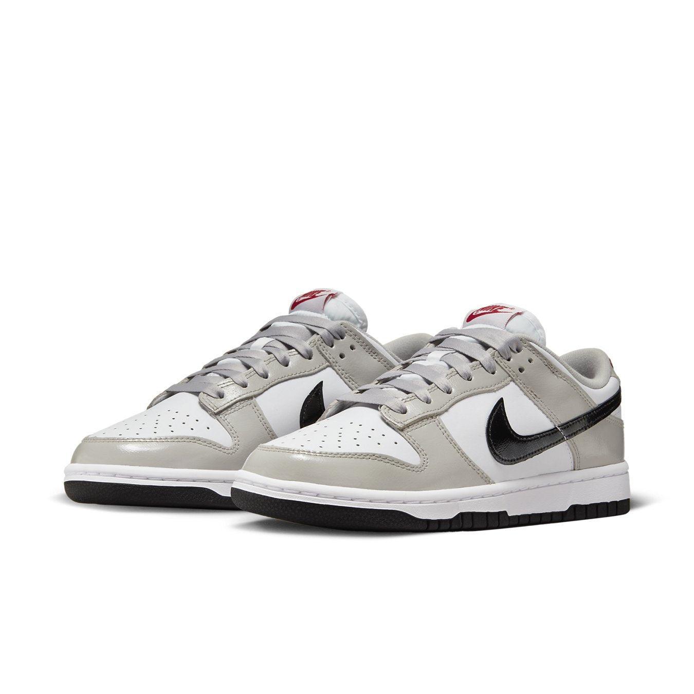 Nike Dunk Low Light Iron Ore sneakers in white, grey, and black with glossy finish for stylish everyday wear.