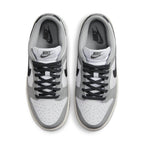 Nike Dunk Low Light Smoke Grey women's sneakers with white leather and black accents, top view.