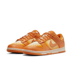 Nike Dunk Low Magma Orange (W) women's sneakers featuring bold orange and cream colorway with signature swoosh.