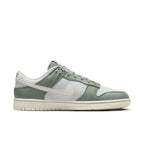 Nike Dunk Low Mica Green sneaker featuring vintage canvas and leather design in cool green tones.