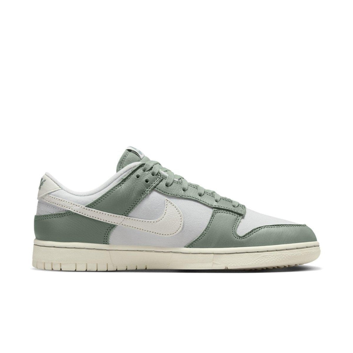 Nike Dunk Low Mica Green sneaker featuring vintage canvas and leather design in cool green tones.
