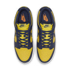 Top view of Nike Dunk Low Michigan 2021 sneakers in Varsity Maize and Midnight Navy with Swoosh logos.