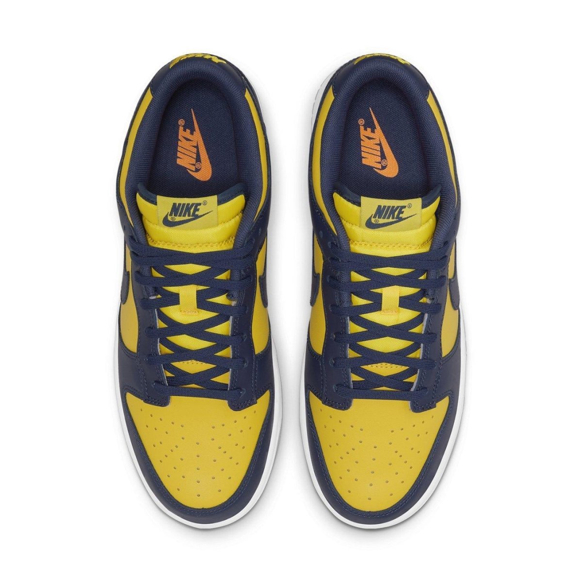Top view of Nike Dunk Low Michigan 2021 sneakers in Varsity Maize and Midnight Navy with Swoosh logos.