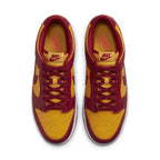 Nike Dunk Low Midas Gold sneakers in yellow and red colorway, featuring leather upper and bold design.