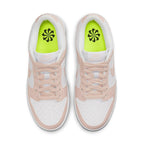 Nike Dunk Low Next Nature Pale Coral women's sneakers with pink overlays and Volt insole.