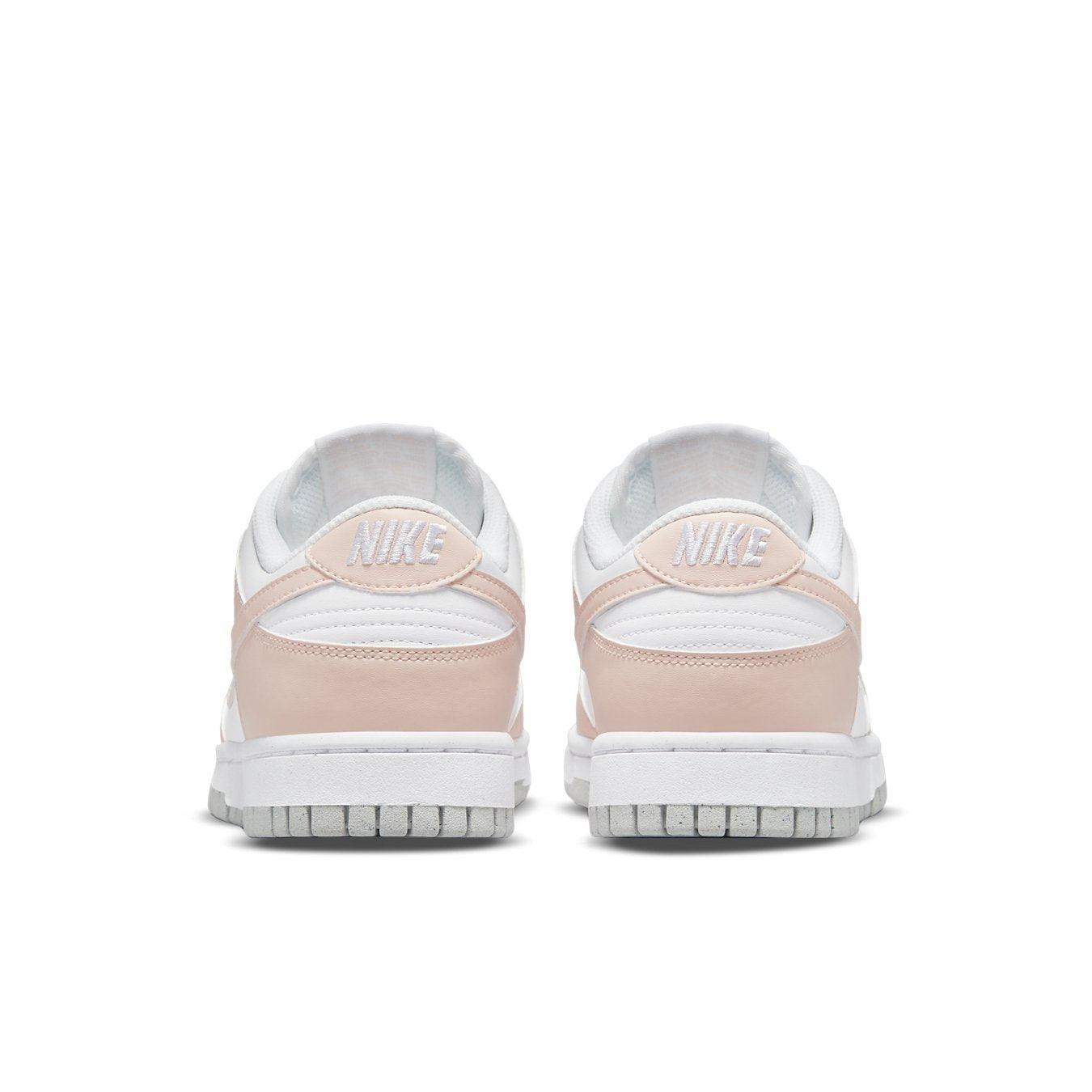Nike Dunk Low Next Nature Pale Coral women's sneaker rear view with pink accents and white base.