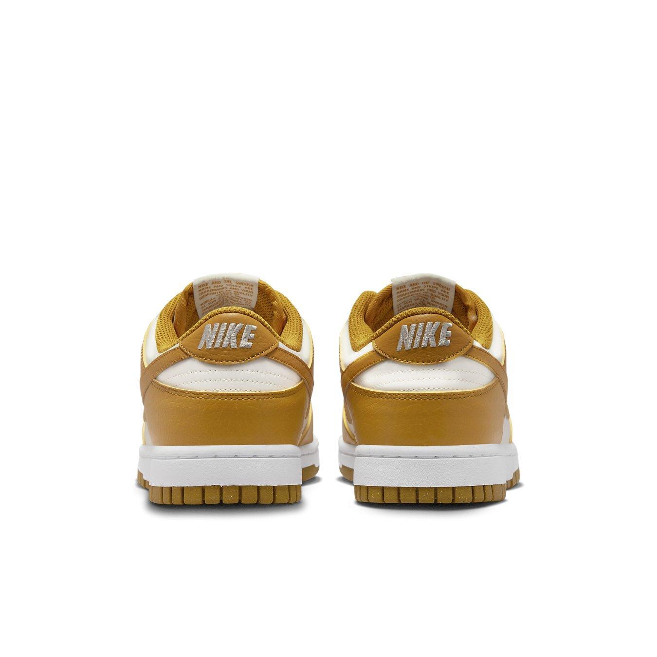 Nike Dunk Low Next Nature Phantom women's sneakers, rear view showcasing amber outer layers and Volt logo.