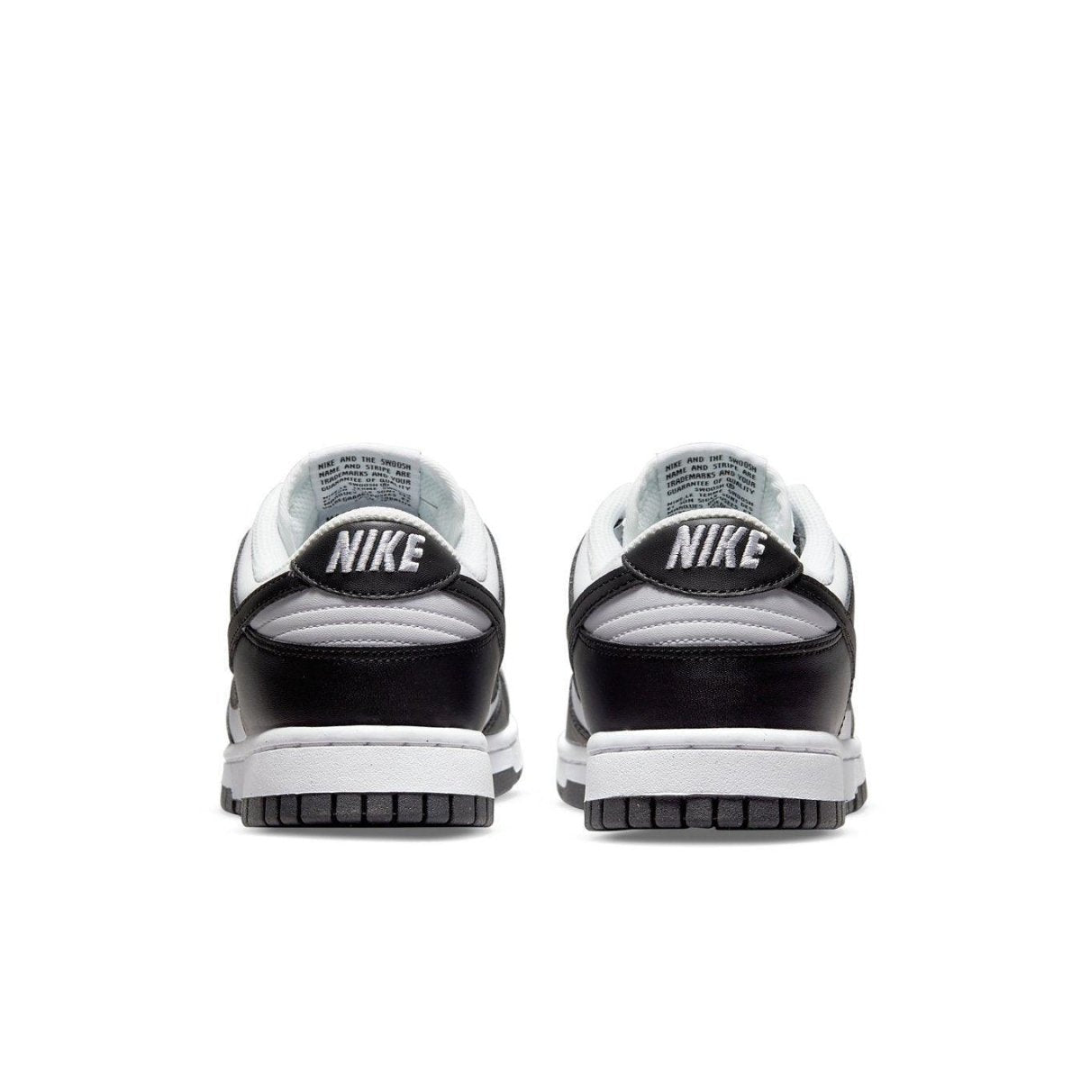 Nike Dunk Low Next Nature shoes in white and black, showcasing a traditional design with modern eco-friendly materials.