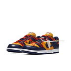 Nike Dunk Low Off-White in University Gold and Midnight Navy with foam tongue and waffle sole design.