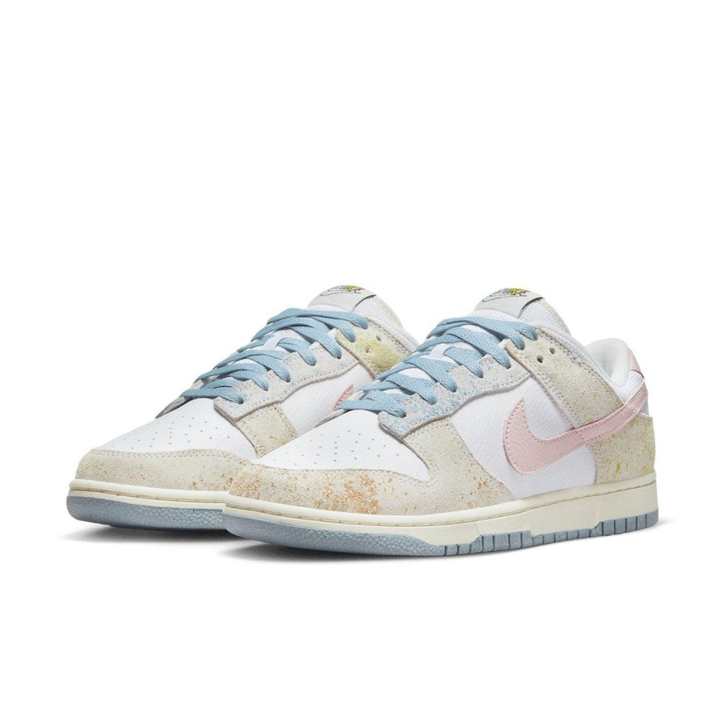 Nike Dunk Low Oxidized in pastel tones with blue, pink, and yellow detailing, featuring a faded suede look.