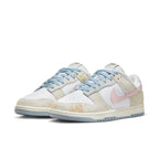 Nike Dunk Low Oxidized in pastel tones with blue, pink, and yellow detailing, featuring a faded suede look.
