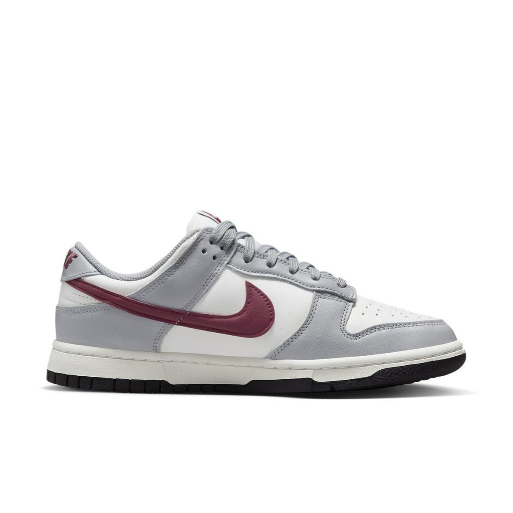 Nike Dunk Low Pale Ivory Redwood sneaker in white leather with gray and red accents.