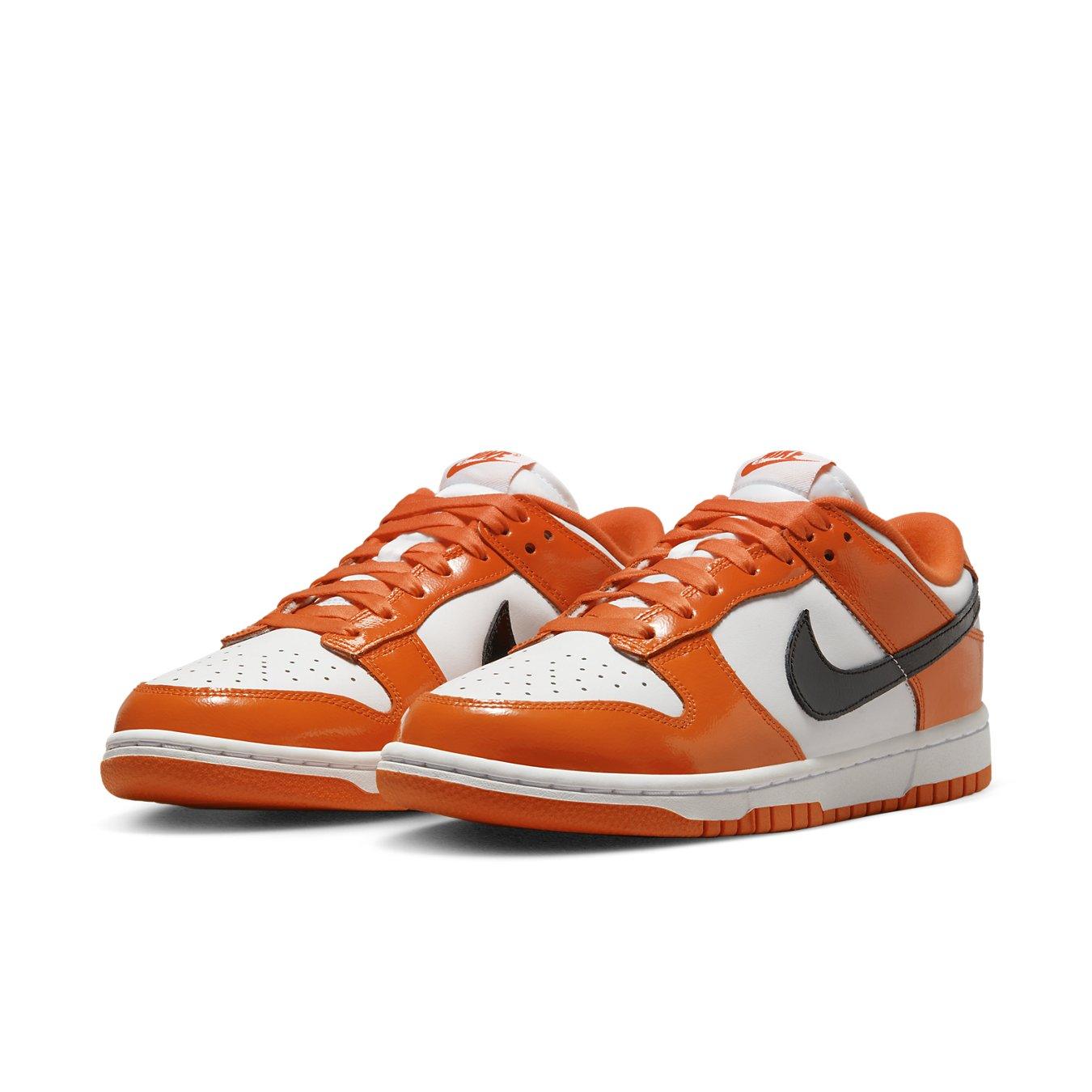 Nike Dunk Low Patent Halloween (W) sneakers in white and vibrant orange with black Swoosh.