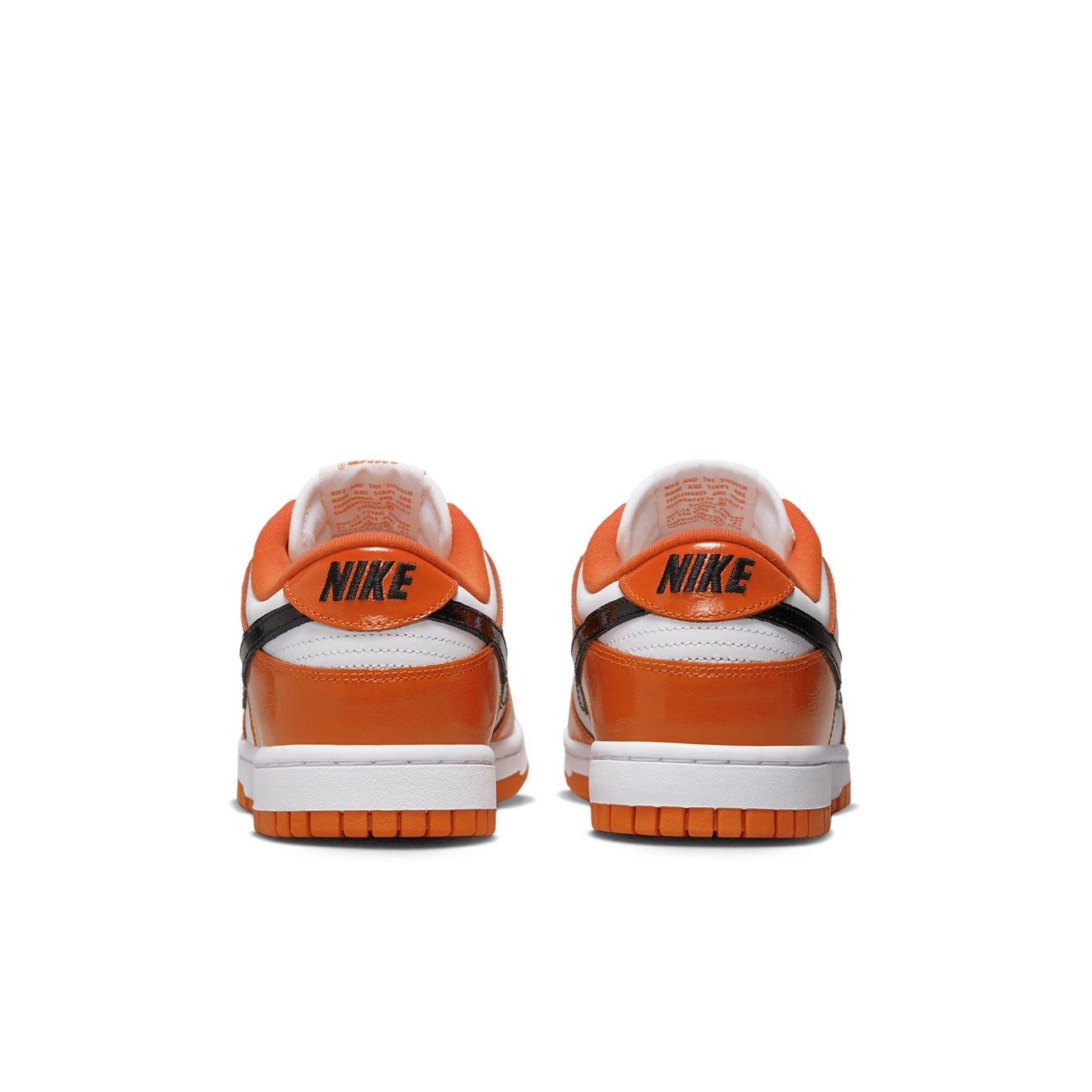 Nike Dunk Low Patent Halloween (W) sneakers featuring a vibrant orange and white design with black Swoosh.
