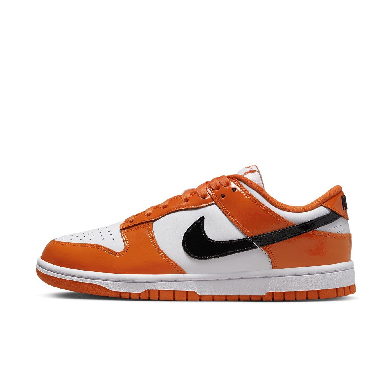Nike Dunk Low Patent Halloween sneakers in white and orange, featuring a black Swoosh and bold design.