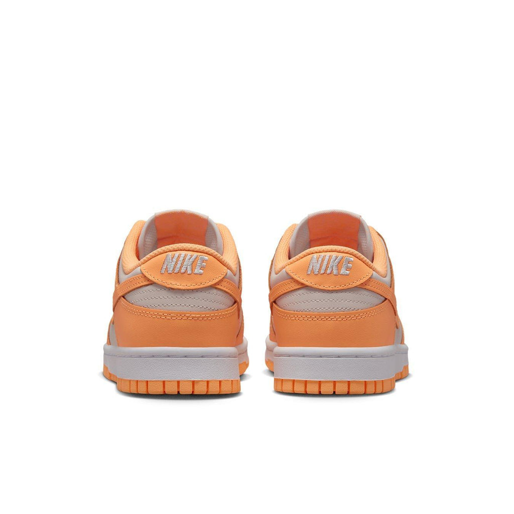 Nike Dunk Low Peach Cream women's sneakers, featuring vibrant orange hues and classic Nike branding.