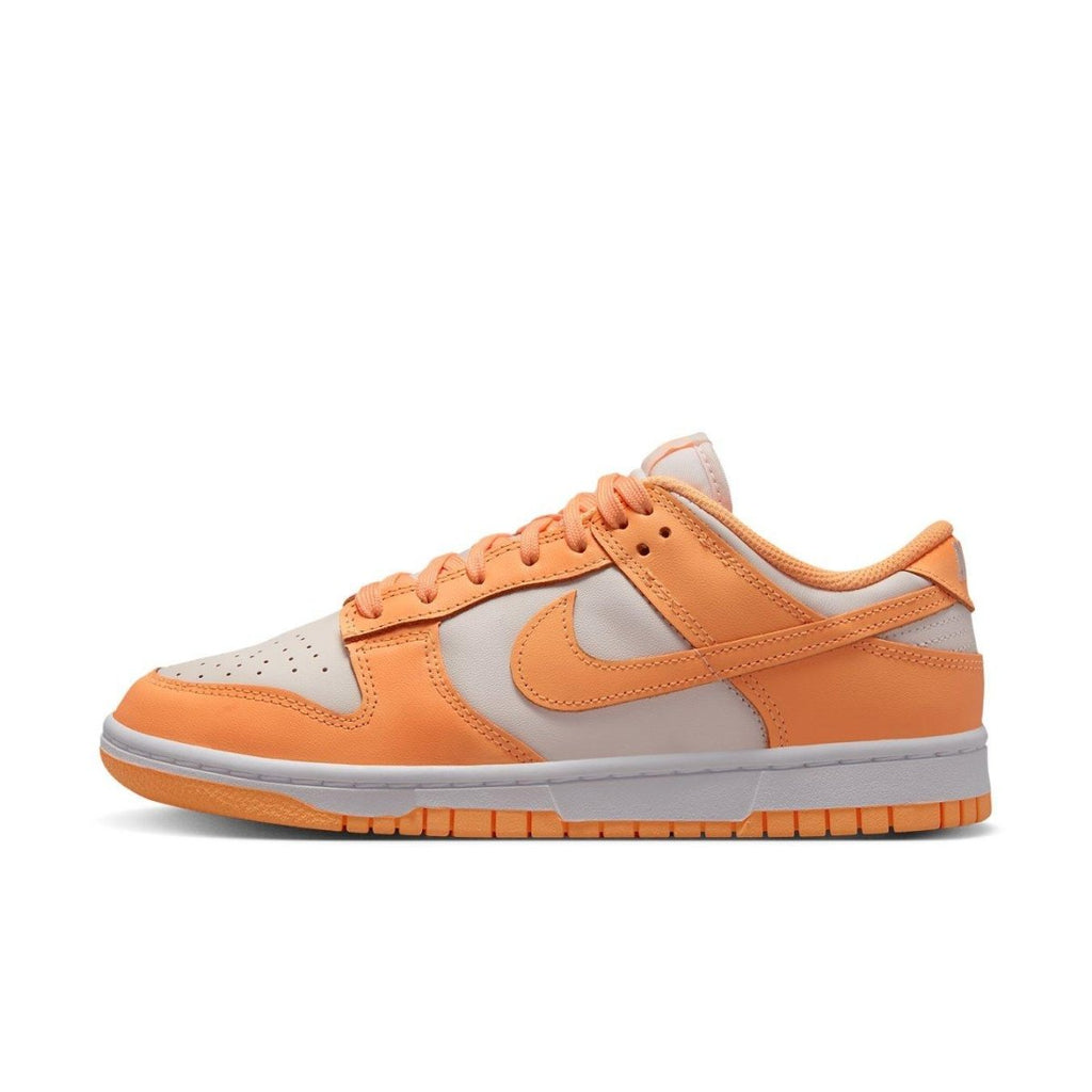 Nike Dunk Low Peach Cream women's sneaker in white and peach colorway, featuring playful design and durable sole.