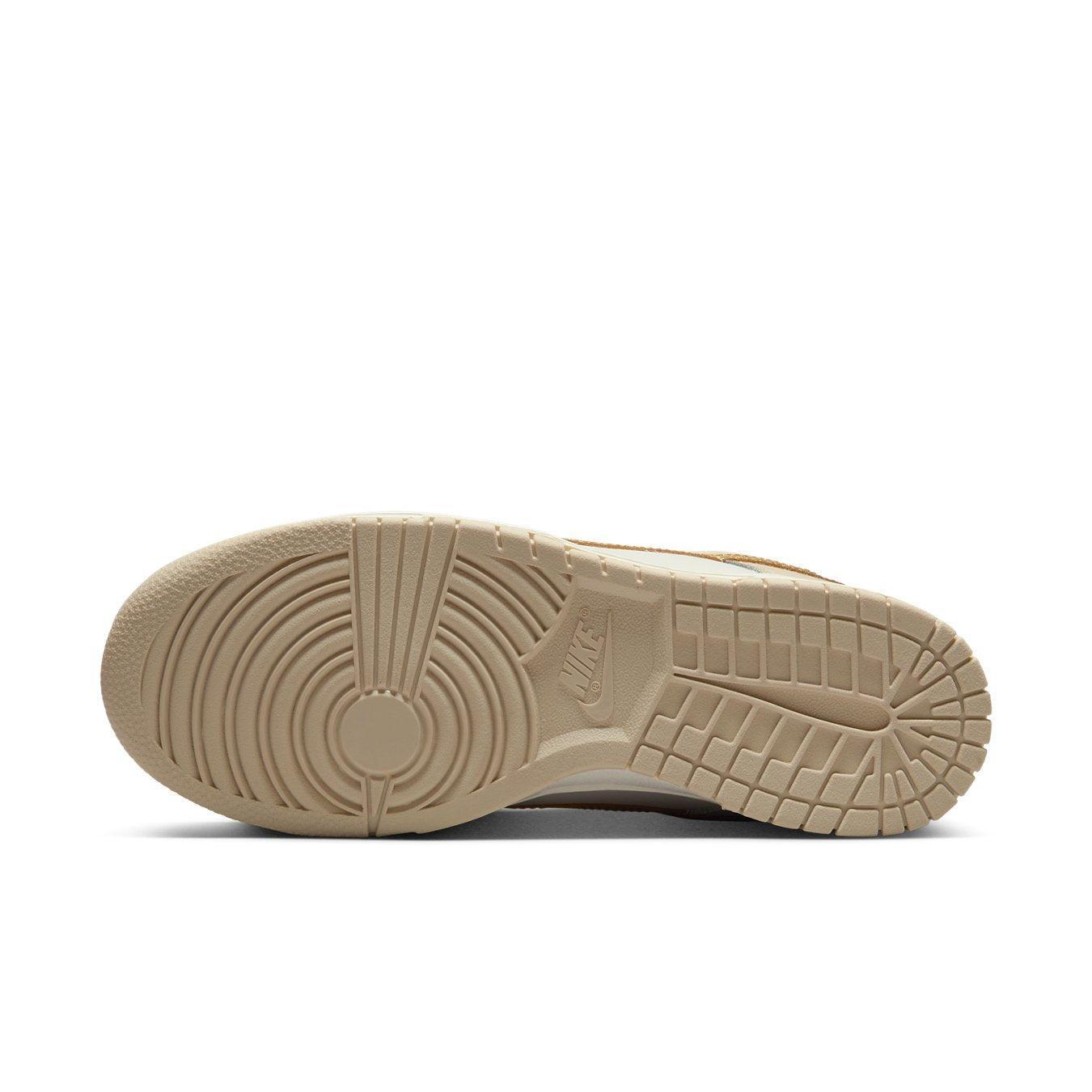 Sole view of Nike Dunk Low Phantom Gold showing smooth beige rubber outsole design.