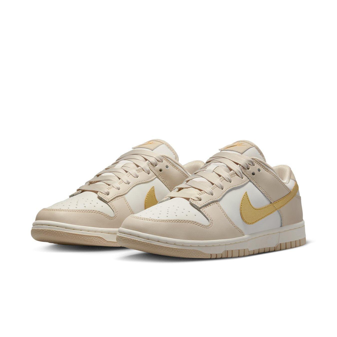 Nike Dunk Low Phantom Metallic Gold sneakers in white and beige with yellow accents and clean design.
