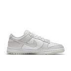 Nike Dunk Low Photon Dust women’s sneaker in gray and white, featuring iconic design and sporty elegance.