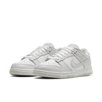 Nike Dunk Low Photon Dust women's sneakers in gray and white, featuring classic design for sport and streetwear.