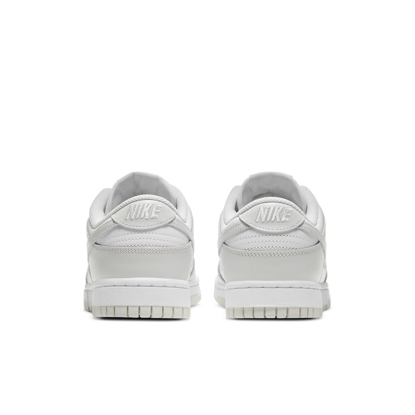 Retro Nike Dunk Low Photon Dust women's sneakers, featuring a sleek white design and iconic branding on the heel.