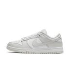 Nike Dunk Low Photon Dust (W) sneaker in white leather with subtle gray accents, showcasing stylish athletic elegance.