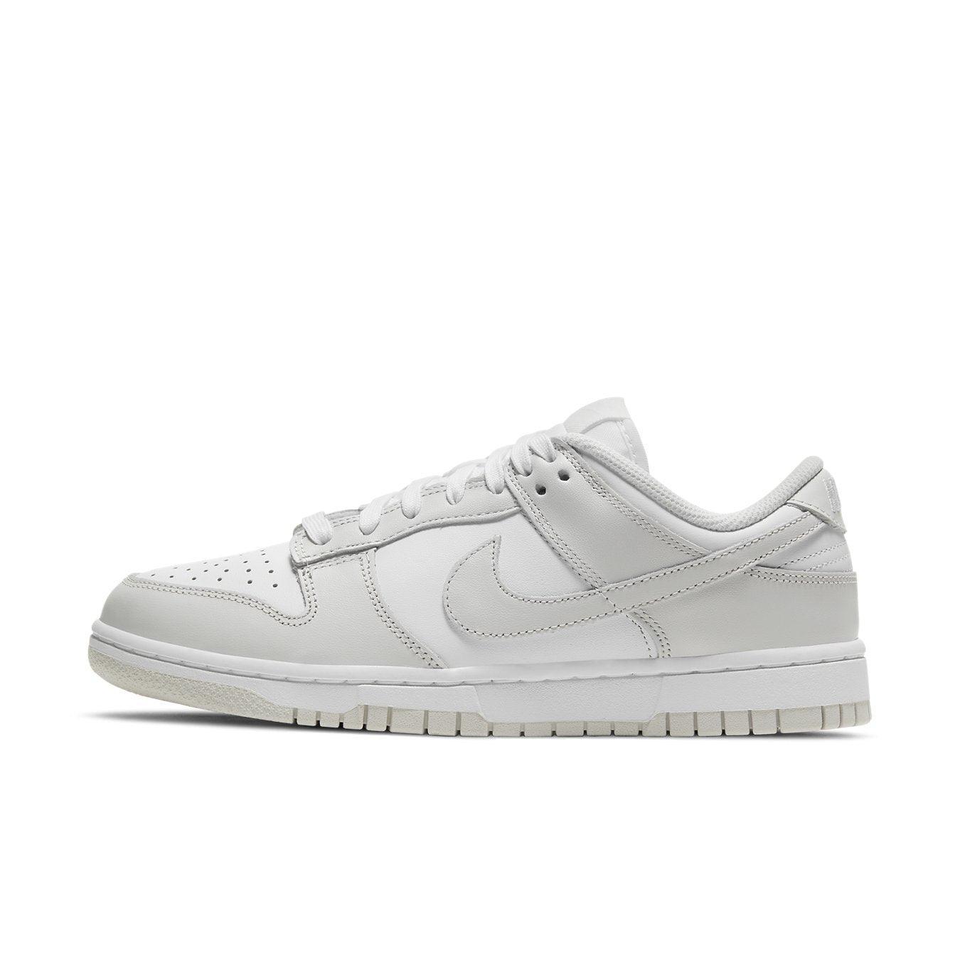 Nike Dunk Low Photon Dust (W) sneaker in white leather with subtle gray accents, showcasing stylish athletic elegance.