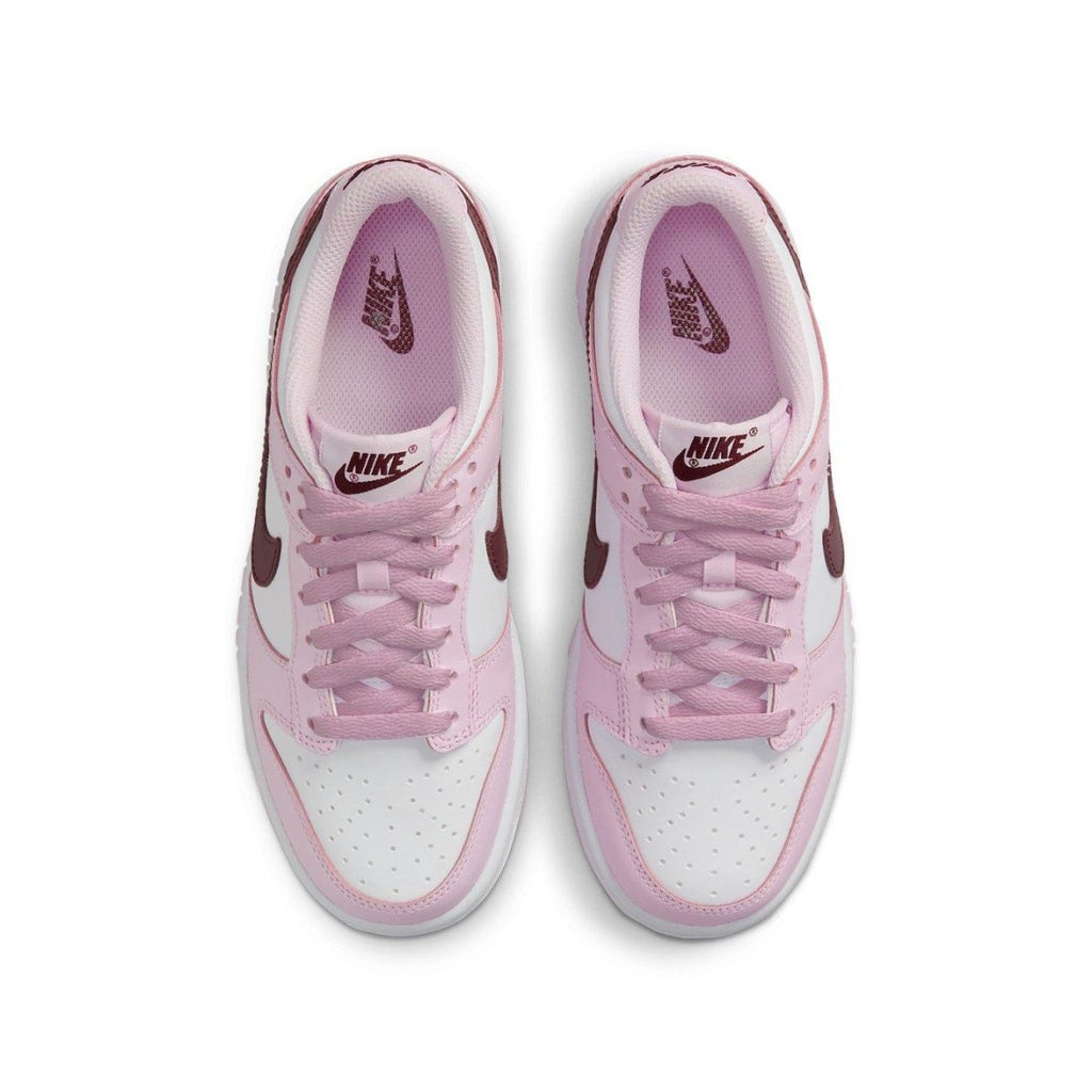 Nike Dunk Low Pink Foam Red White (GS) sneakers with pink overlays and deep red Swoosh, viewed from above.