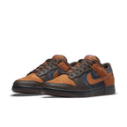Nike Dunk Low PRM Cider sneaker featuring burnt orange suede and brown leather accents.
