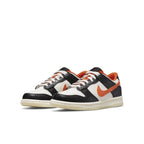 Nike Dunk Low PRM Halloween (2021) GS in black, white, and orange colorway, showcasing festive design for kids.