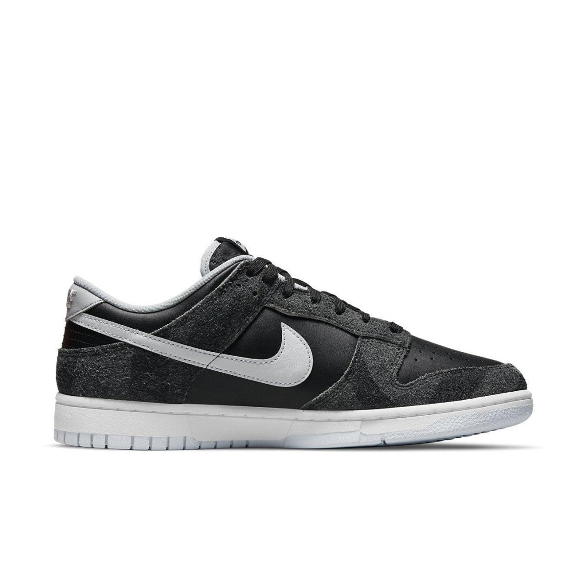 Nike Dunk Low Retro Animal Pack Zebra shoes in black and grey with iconic Swoosh design.