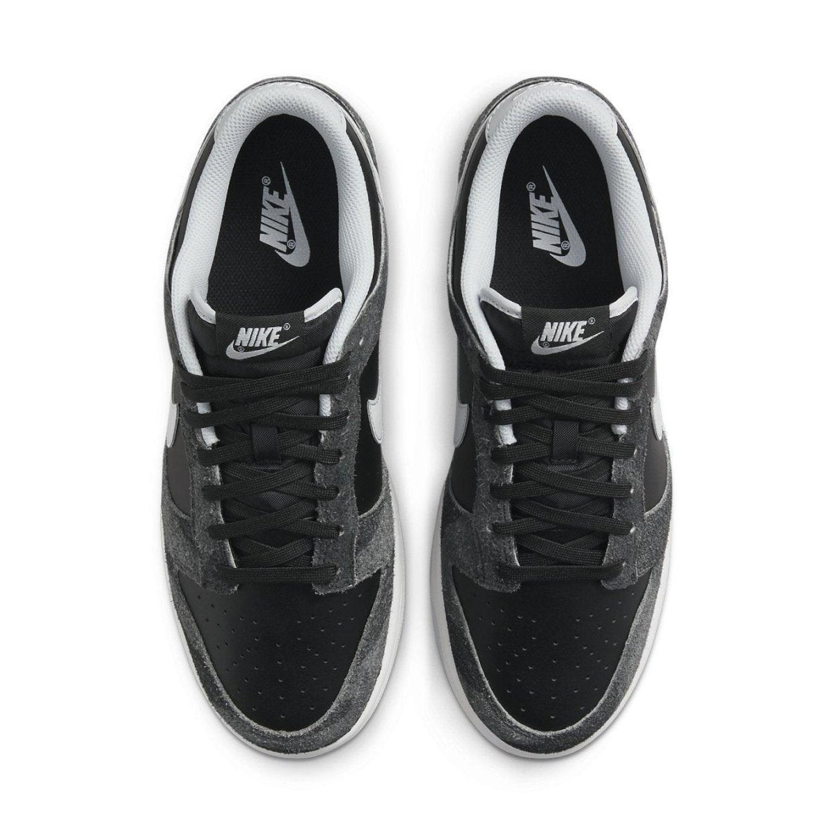 Nike Dunk Low Retro Animal Pack Zebra shoes with black and gray design, featuring iconic Swoosh logo and signature branding.