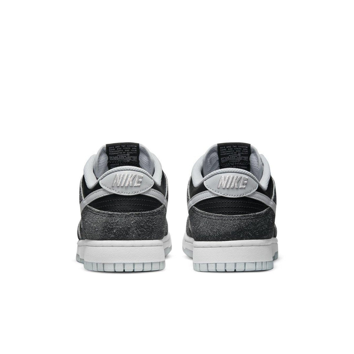 Back view of Nike Dunk Low Retro Animal Pack Zebra sneakers in black and gray with classic Swoosh design.