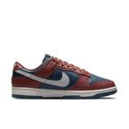 Nike Dunk Low Retro Canyon Rust women's sneakers with navy and rust leather upper, white Swoosh.
