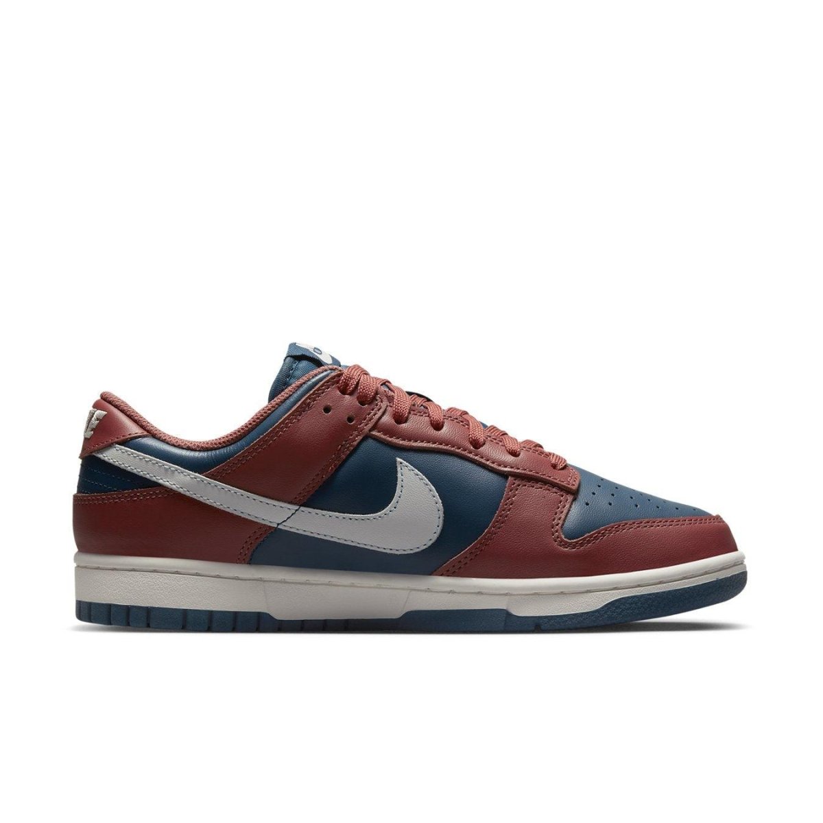 Nike Dunk Low Retro Canyon Rust women's sneakers with navy and rust leather upper, white Swoosh.