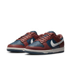 Nike Dunk Low Retro Canyon Rust in navy and rust leather with white Swoosh and midsole.