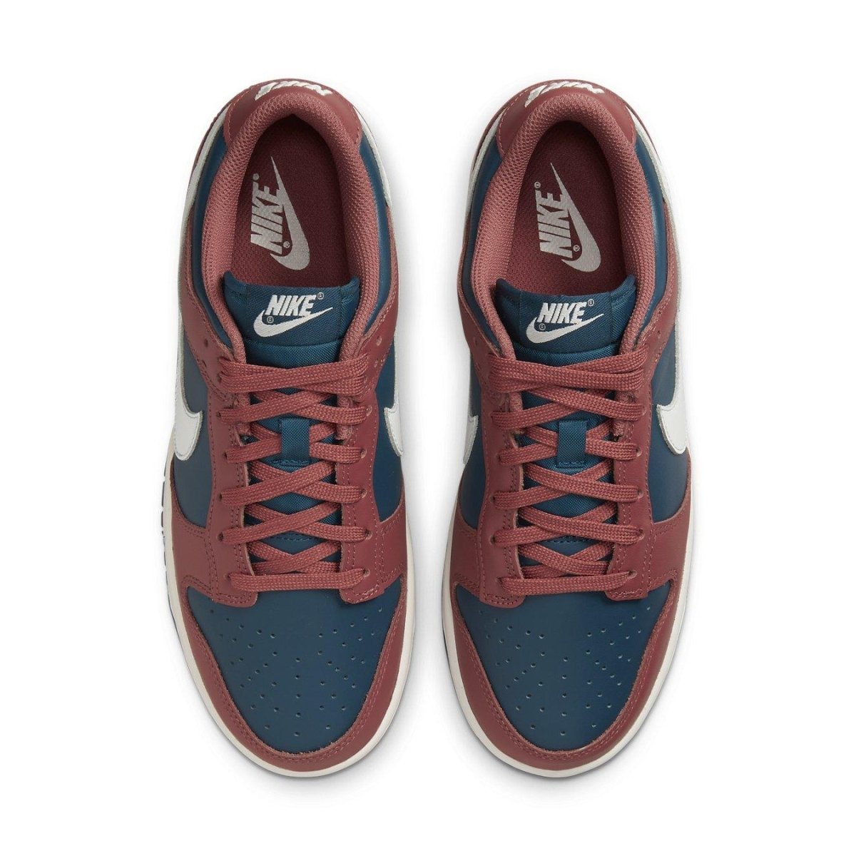 Nike Dunk Low Retro Canyon Rust women's sneakers in navy and rust with white Swoosh and laces.
