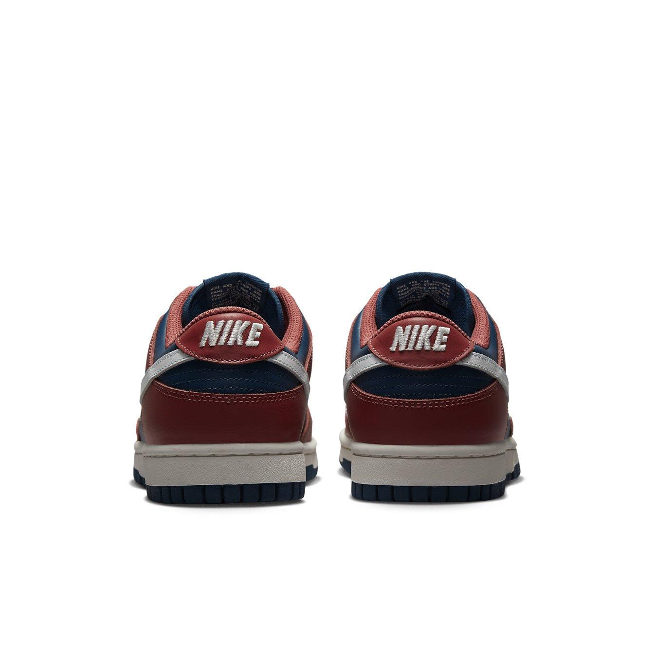 Nike Dunk Low Retro Canyon Rust (W) rear view showcasing navy and rust leather details with white branding.