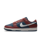 Nike Dunk Low Retro Canyon Rust (W) in navy leather with rust accents and white Swoosh, stylish sneaker profile shot.