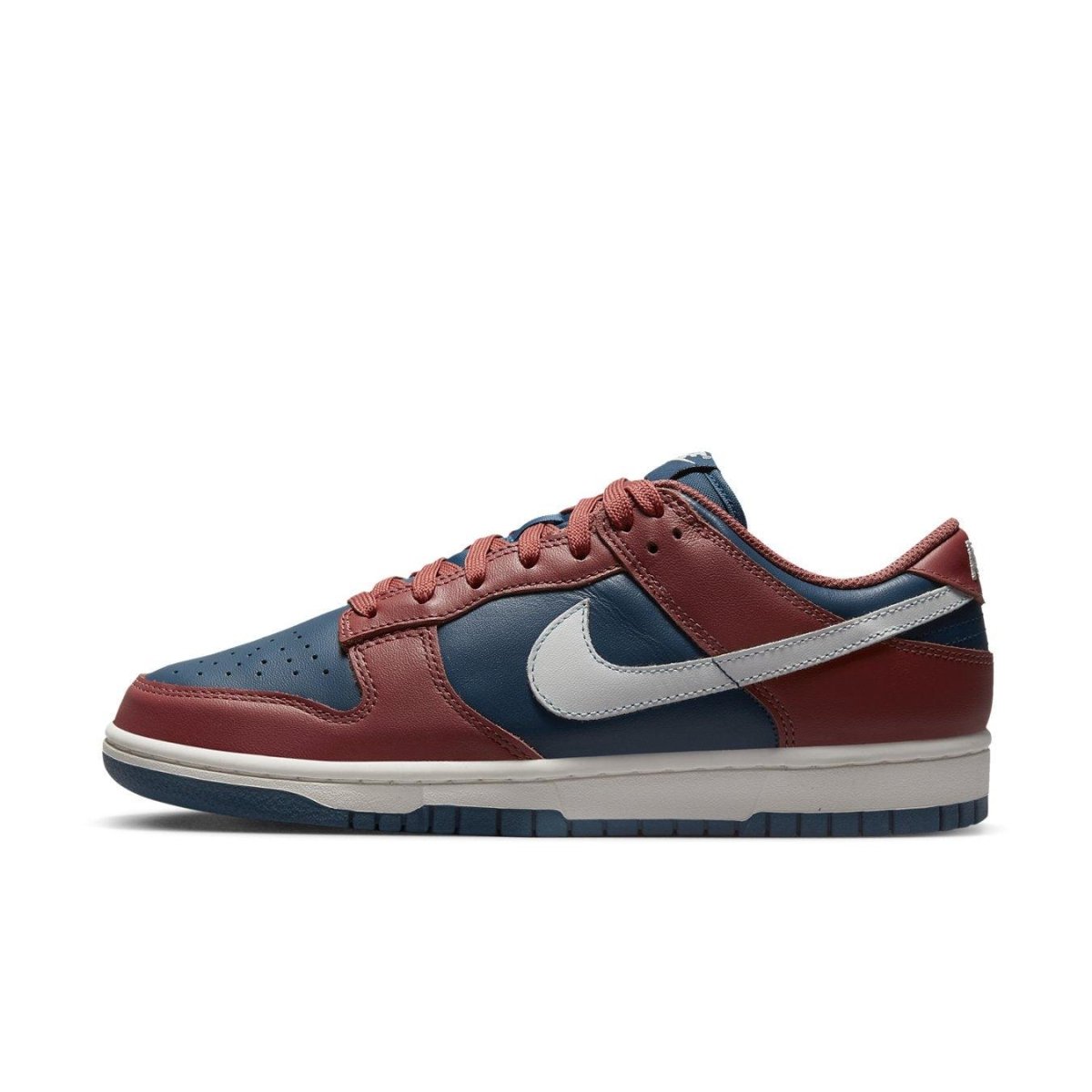 Nike Dunk Low Retro Canyon Rust (W) in navy leather with rust accents and white Swoosh, stylish sneaker profile shot.