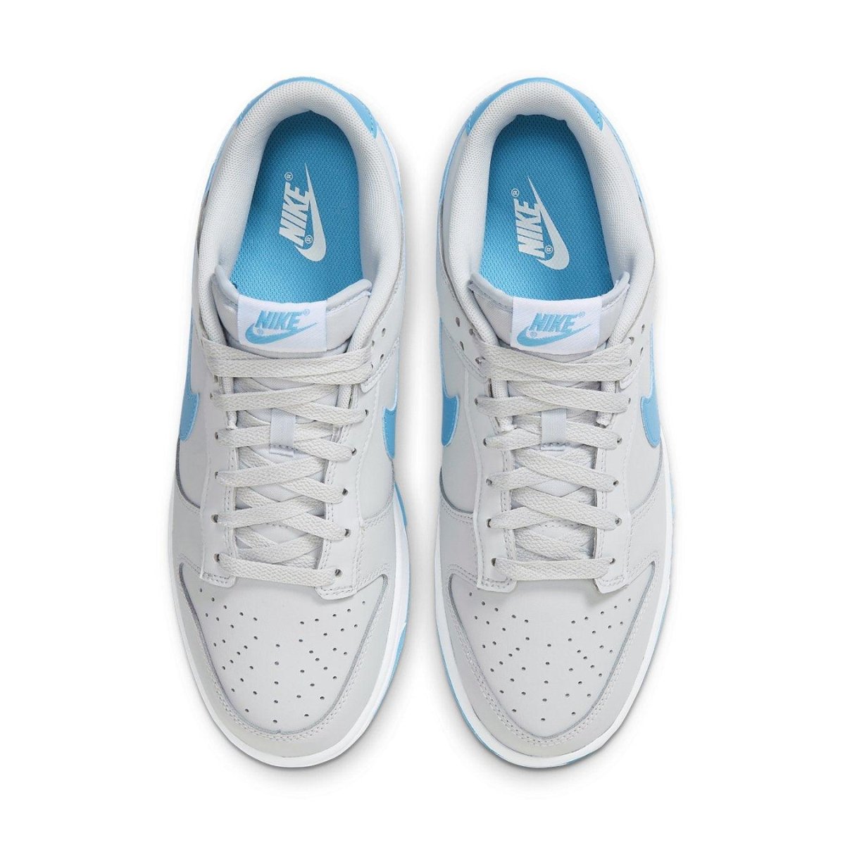 Nike Dunk Low Retro Pure Platinum Blue Lightning sneakers in gray and blue colorway, showcasing lace-up and perforated design.